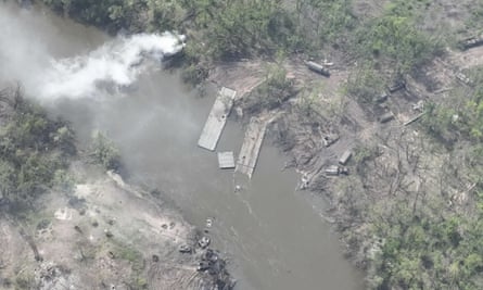 An aerial photo of a ruined pontoon crossing with dozens of destroyed Russian armoured vehicles on the banks of Siverskyi Donets River,