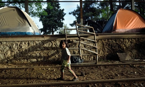A child walks along railway tracks near the Greek village of Idomeni