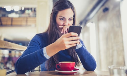 Worried young woman using smartphone
