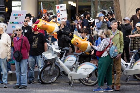 Balloons depicting President Donald Trump float among demonstrators and signs at a “No Kings” protest on March 28, 2026 in San Francisco, California.