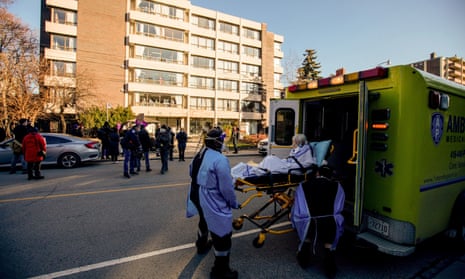 A woman is placed in an ambulance outside the Sienna St George long-term care home in Toronto on Thursday.