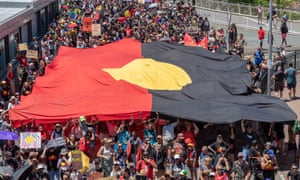 Protesters with a giant Aboriginal flag