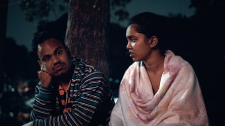 A man and a woman talk outside