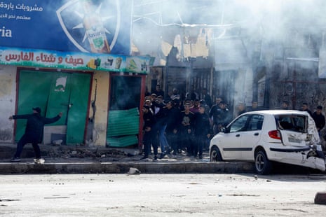 Palestinian protesters hurl rocks at Israeli army vehicles after a raid in the Balata refugee camp, east of Nablus city in the occupied West Bank.