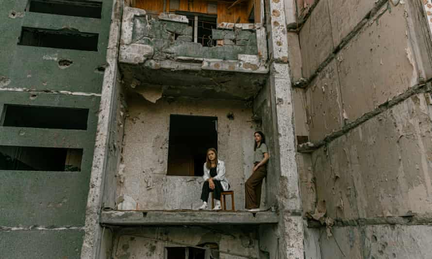 Students pose at a damaged building for a high school graduation photoshoot in Chernihiv, Ukraine.