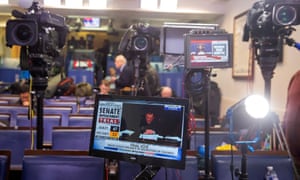 Members of the media watch TV monitors as the Senate votes to acquit Trump