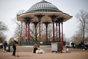 A member of the Clapham women’s institute clears the Clapham Common bandstand after removing floral tributes and placards from a makeshift memorial for the murdered Sarah Everard.