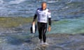 US surfer Kelly Slater holds his board as he walks out of the water after competing at the Margaret River Pro surfing competition