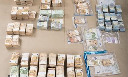 A handout image made available by the Belgium Police Judiciaire Federale shows several hundred thousand euros found in a hotel room.