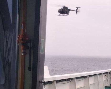 A screengrab from footage published by Russian state media allegedly showing a US helicopter approaching the sanctioned oil tanker in European waters.