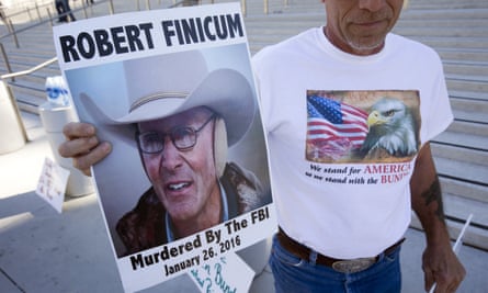 Randy Peck of Las Vegas, a supporter of Nevada rancher Cliven Bundy, holds a sign of LaVoy Finicum in downtown Las Vegas.
