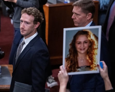 Zuckerberg stepping past personification holding up a photograph of a unfortunate of kid exploitation