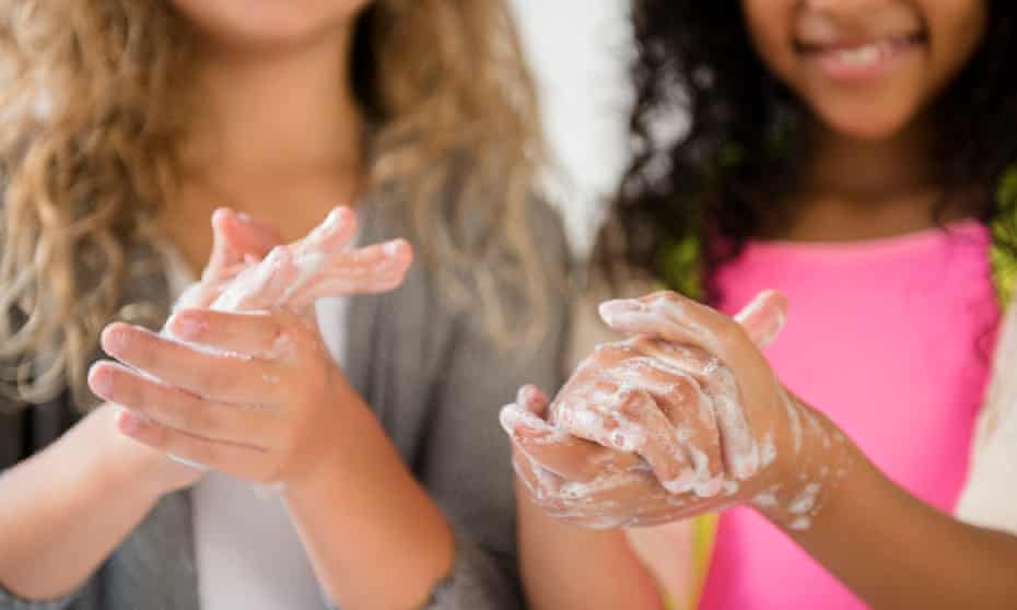 Girls washing hands with soap