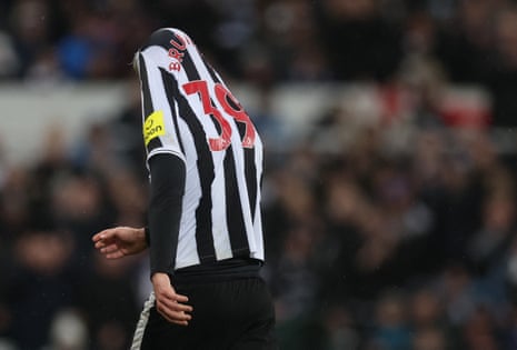 Bruno Guimaraes looks dejected as he walks off after being shown a red card.
