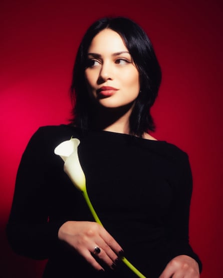 a woman holding a flower