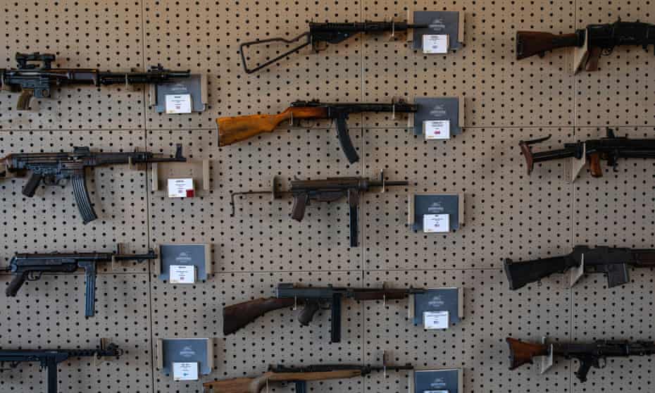 Historic firearms, which can be shot by visitors, are displayed on a wall at the living military museum at the Ox Ranch.
