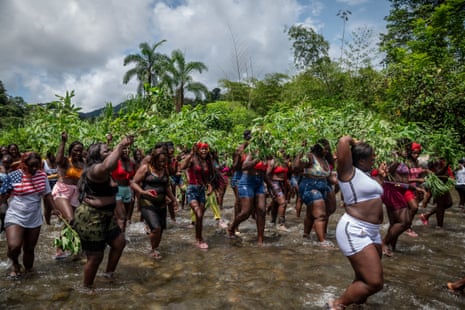 Women from the community walk along part of the Yurumanguí River