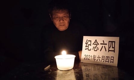 Chen Siming sits by candlelight beside a notice that reads ‘Commemorate June 4 on 2021 June 4’ in central China’s Hunan province on that day