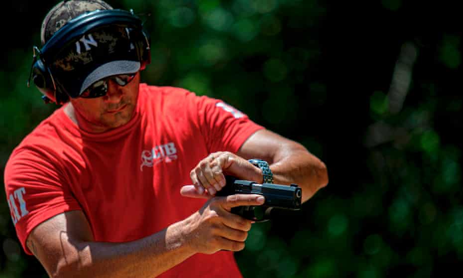 An instructor prepares a gun at a shooting club in Belém, Pará state, Brazil, on 25 July. 