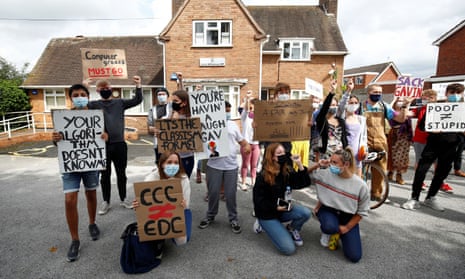 A-level students hold placards as they protest about their exam results at the constituency offices of Education Secretary Gavin Williamson, in South Staffordshire today.
