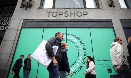 People walk past 214 Oxford Street, the former flagship store of British fashion chain Topshop