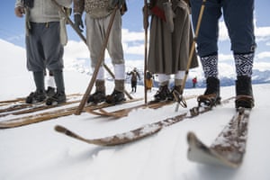 People stand on old wooden skis