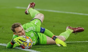 Bayern Munich's keeper Manuel Neuer stops the ball from going out for a corner after making a save against Arsenal.