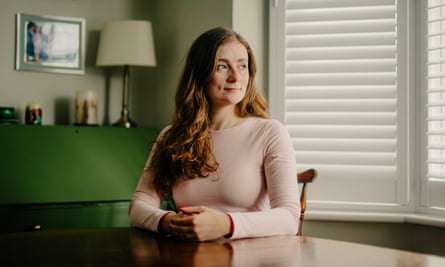 A young woman in her host’s home, sitting at a dining table.