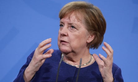 Angela Merkel gesturing with both hands.