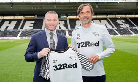 Wayne Rooney poses with the Derby County manager, Phillip Cocu, after signing for the club.