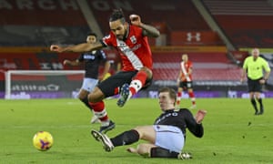 Southampton’s Theo Walcott jumps over a challenge by Aston Villa’s Matt Targett.