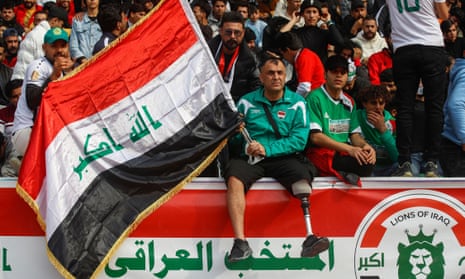 An Iraq supporter lifts a national flag
