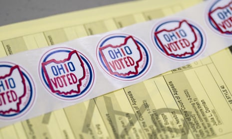 Voting stickers lie in front of a sample ballot for the 2022 midterm elections at a polling location inside the St. Olivet Baptist Church in Columbus, Ohio.