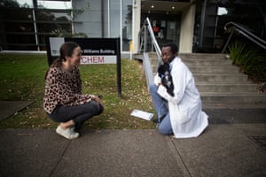 Skye Welsh hands over her cavoodle, Jessie, to Dr Phan Mponda for surgery.