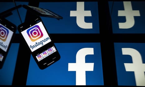 A photo illustration showing Facebook logos on four tablet screens as a background to a mobile phone displaying an Instagram logo.