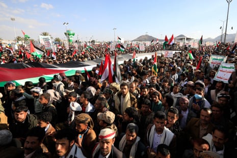 People hold a large Palestinian flag during a protest against a multinational operation to safeguard Red Sea shipping and in solidarity with the Palestinian people, in Sana’a, Yemen, 05 January 2024.