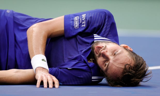 Daniil Medvedev lies on the court in disbelief after beating world No 1 Novak Djokovic at Arthur Ashe Stadium. 