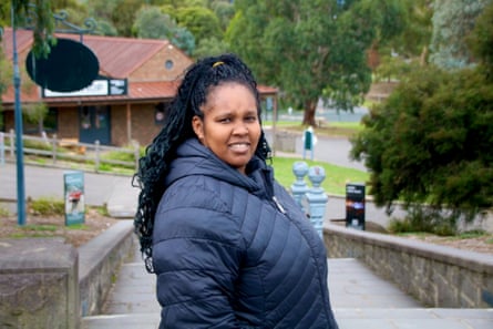 Ann Mureithi wears a puffer jacket and stands on a paved park walkway in Pakenham, Melbourne