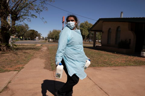 Katrina Hunter delivers milk to a person who is isolating due to the COVID outbreak in Wilcannia. 