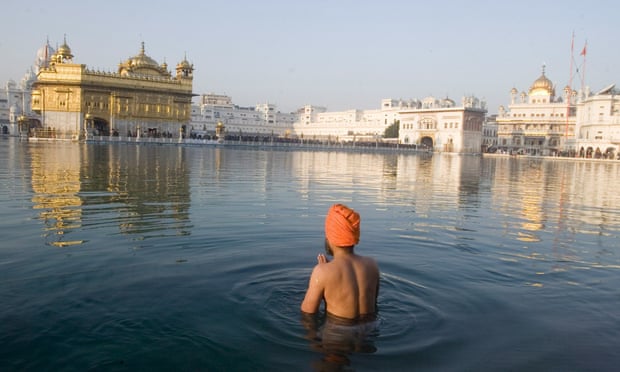 A Sikh man in the sacred pond of the Golden Temple, Amritsar