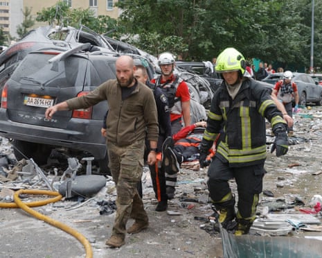 Ukrainian rescuers work at the site of a Russian missile strike on a residential area in Kyiv, Ukraine,