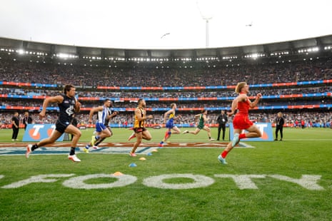 Gold Coast's Jed Walter takes the lead from Brandon Leary of Tasmania