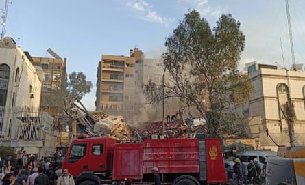 Debris is cleared away from the Iranian consulate in Syria.