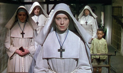 Deborah Kerr dressed as a nun, at the head of a group of nuns, in a still from the film Black Narcissus.