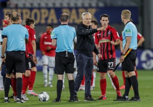 Freiburg’s manager Christian Streich has a word with the referee after the final whistle.