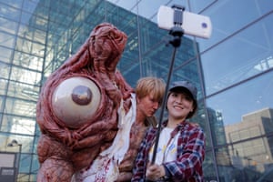 Chen Yifa from China poses for a selfie with a man dressed as William Birkin from Resident Evil