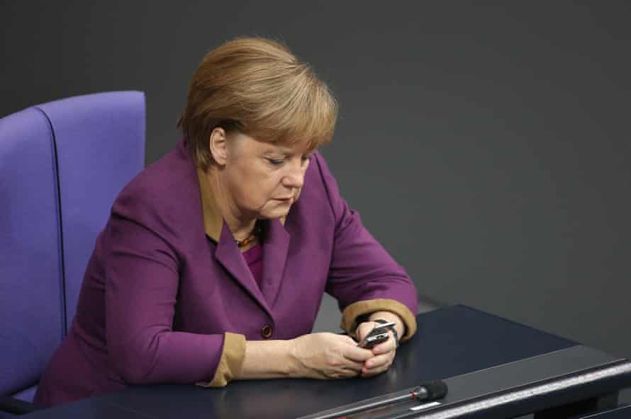 Merkel checks her phone during a session of the Bundestag in November 2012