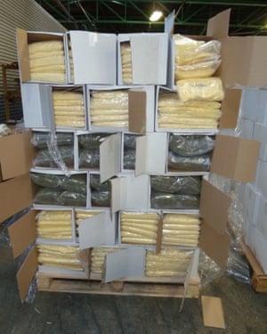 Boxes of cannabis and pizza cheese stacked