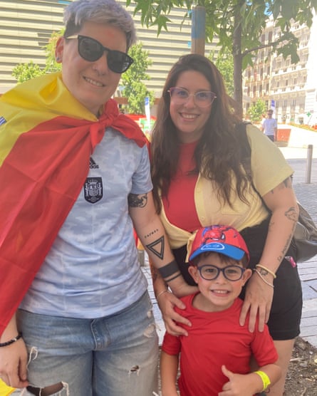 Laura Luengo (left, draped in a Spanish flag) with her wife, Tamara Rodríguez, and their son, Álvaro