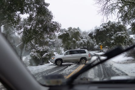 A driver turns around after local rangers closed a road covered by snow in Palo Alto, California, on 24 February 2023.